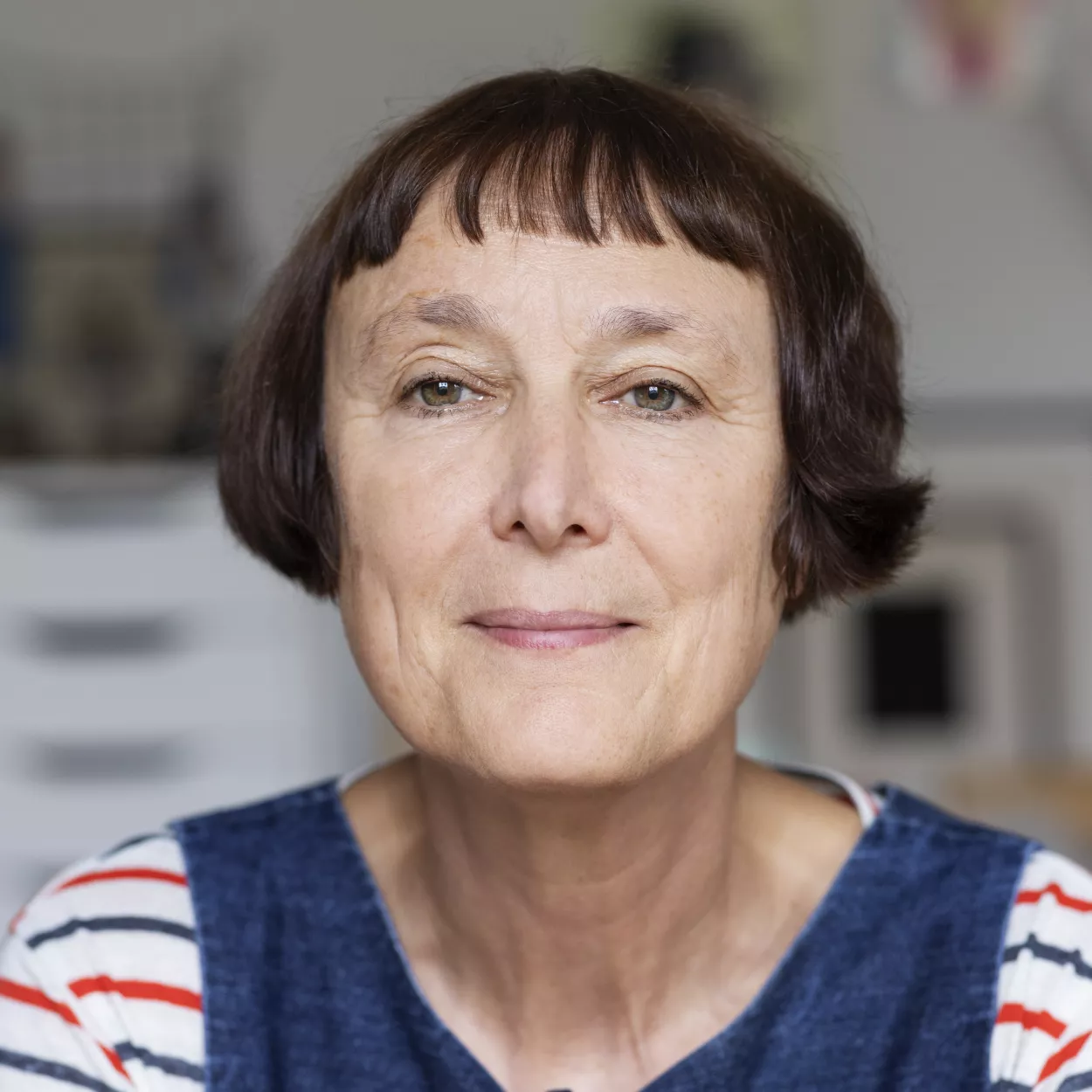 Cornelia Parker is wearing a stripy top and blue overall.