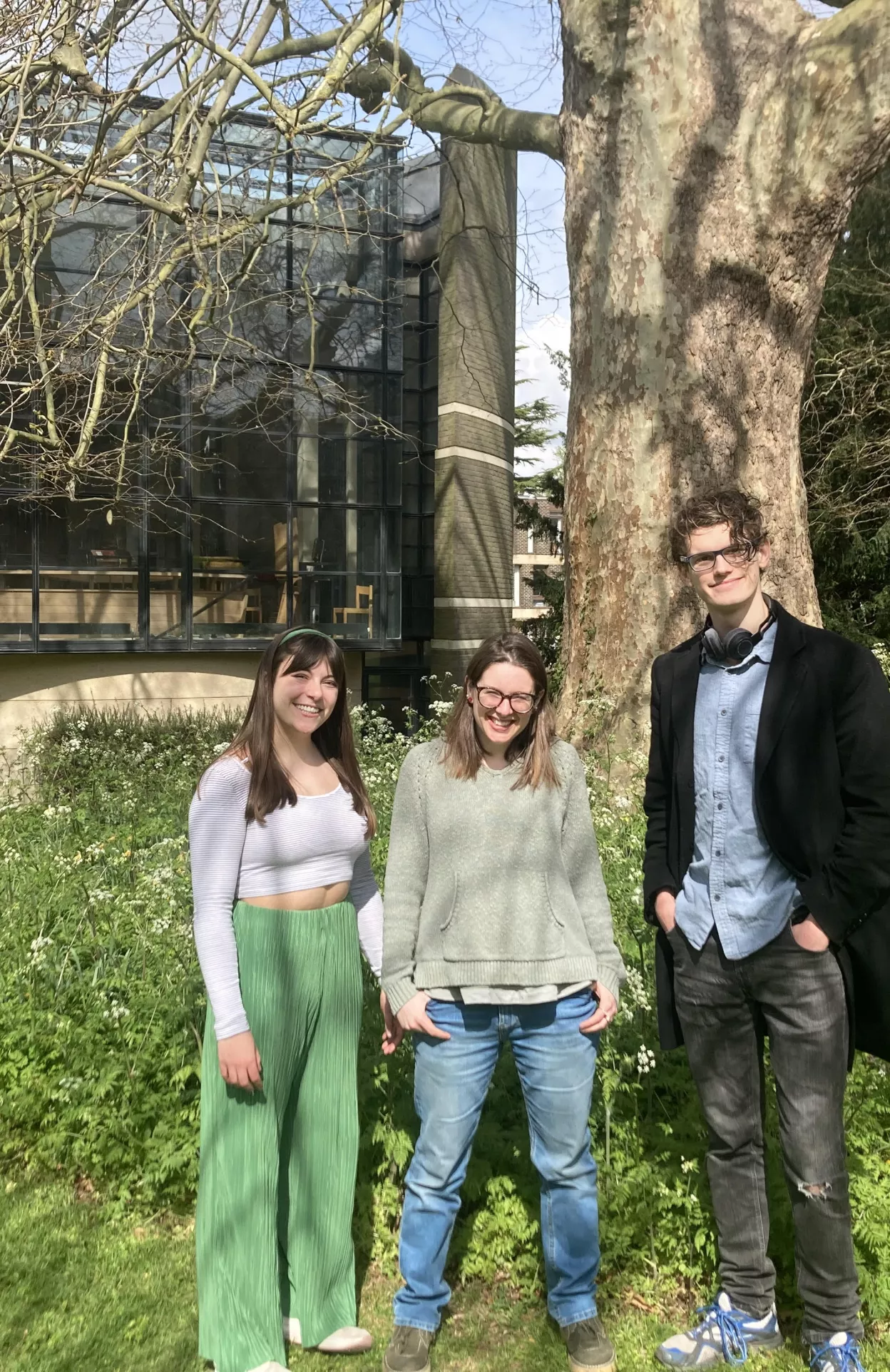 students stood in front of tree