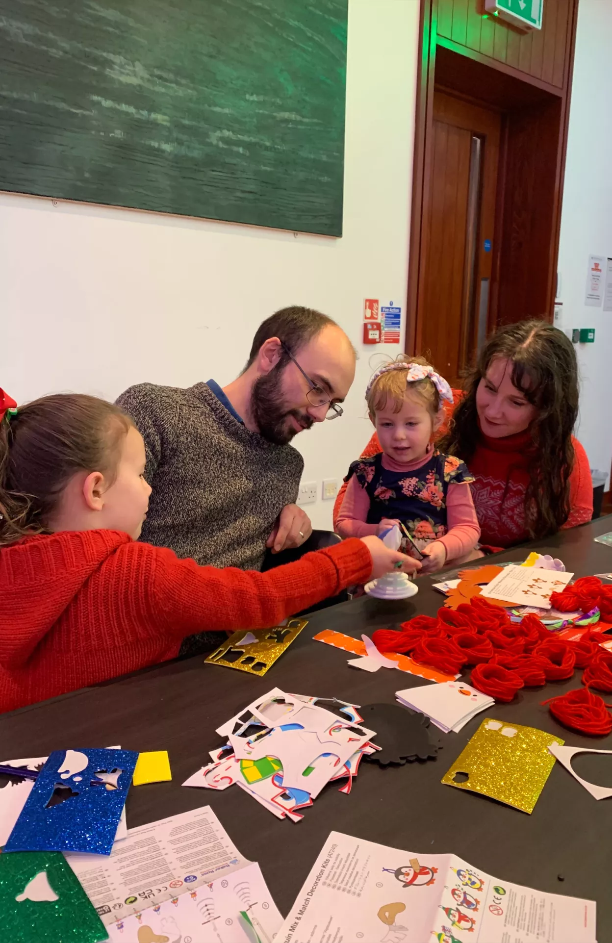 Image of a family completing Christmas themed crafts