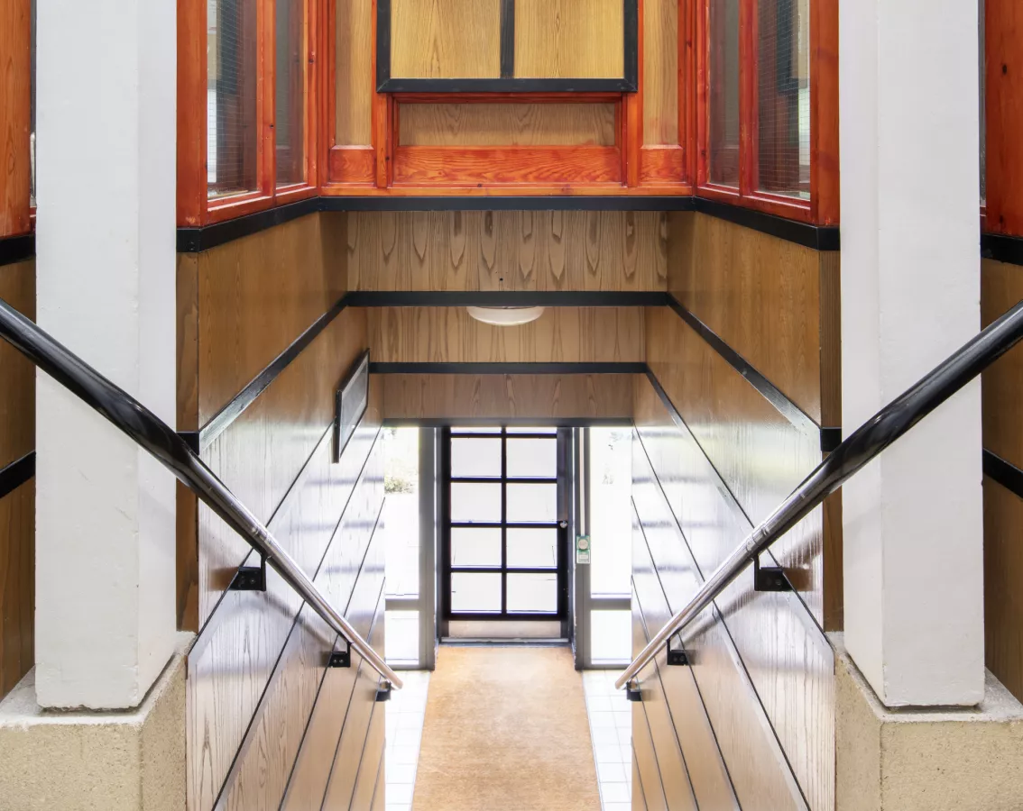 Newly listed at Grade II:  New Court, Fitzwilliam College, Cambridge Fitzwilliam College, Storeys Way, Cambridge, Cambridgeshire.  Interior view of New Court, 1985 by MacCormac, Jamieson, Pritchard (MJP Architects). Residential block showing intersecting staircase. View from north west. © Historic England Archive