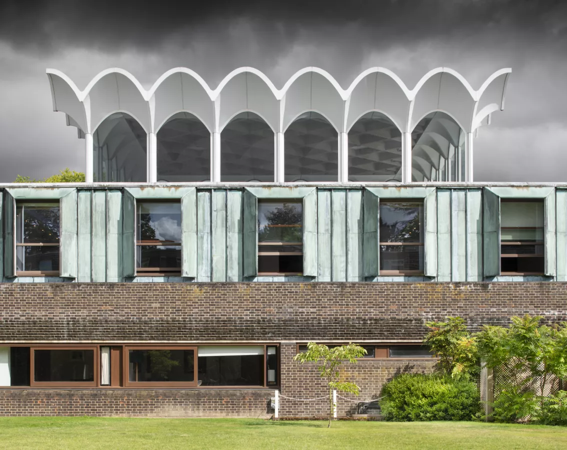 Newly listed at Grade II: The Central Hall, Fitzwilliam College, Cambridge Fitzwilliam College, Storeys Way, Cambridge, Cambridgeshire. General view of west elevation to central hall, comprising dining hall, kitchens and communal spaces, designed by Denys Lasdun, built 1960-63. View from west. © Historic England Archive