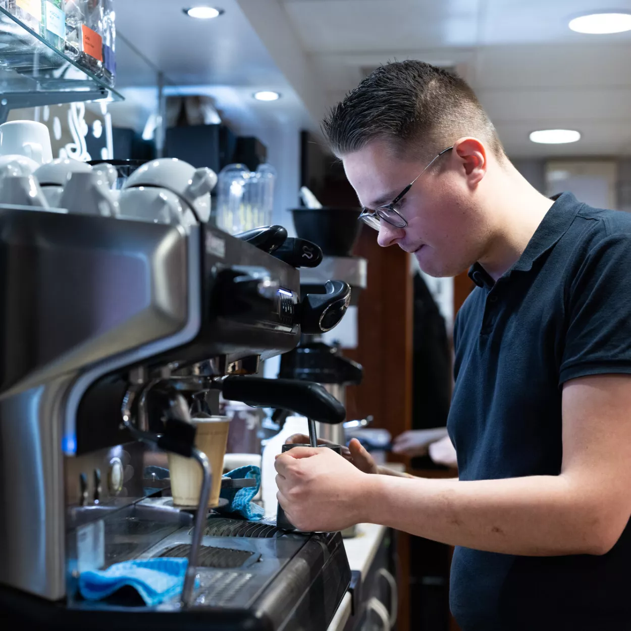 Staff member making coffee